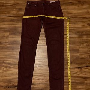 Woman’s maroon skinny jeans, size 5/27.